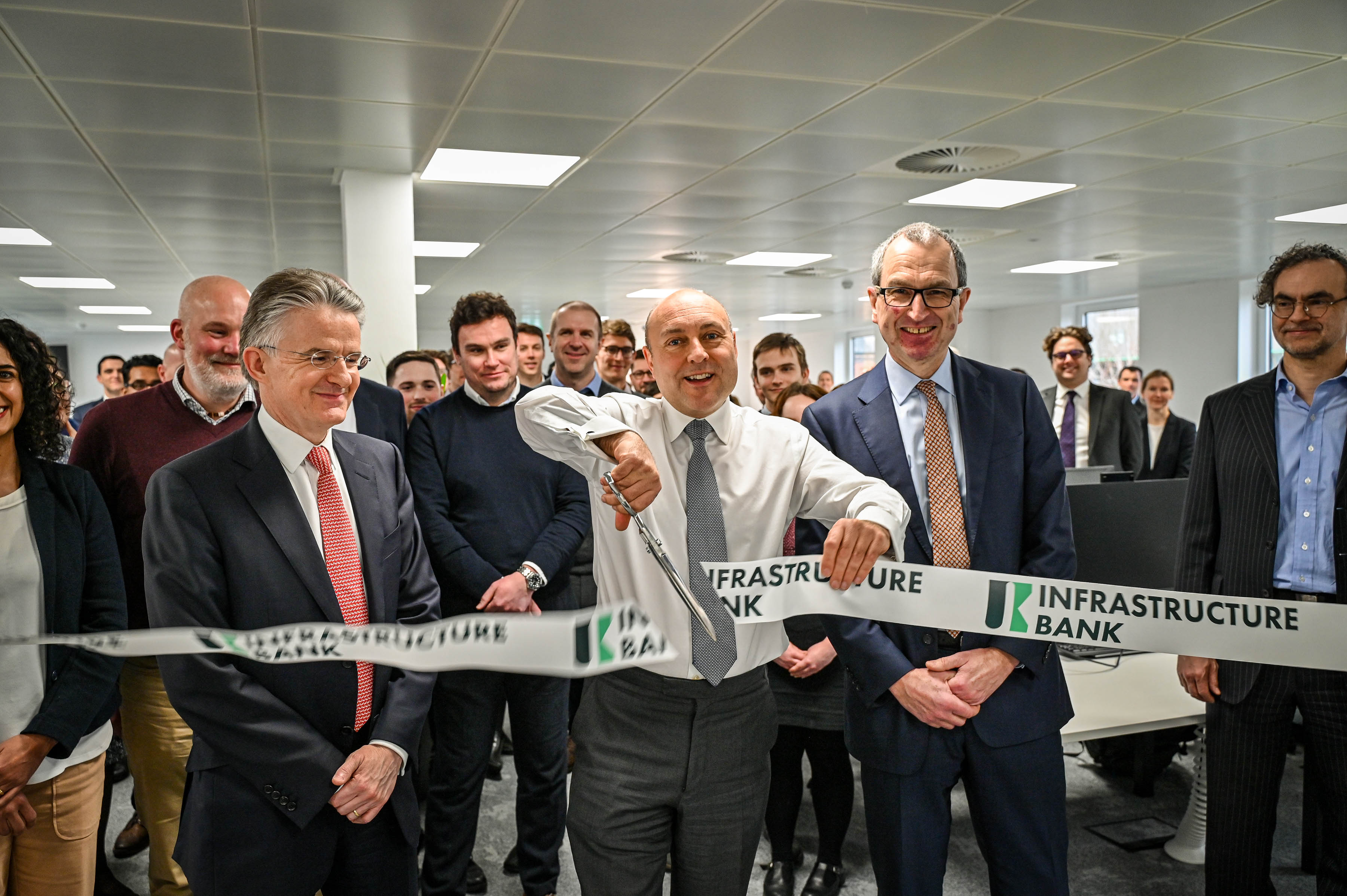 Man cutting ribbon at opening ceremony